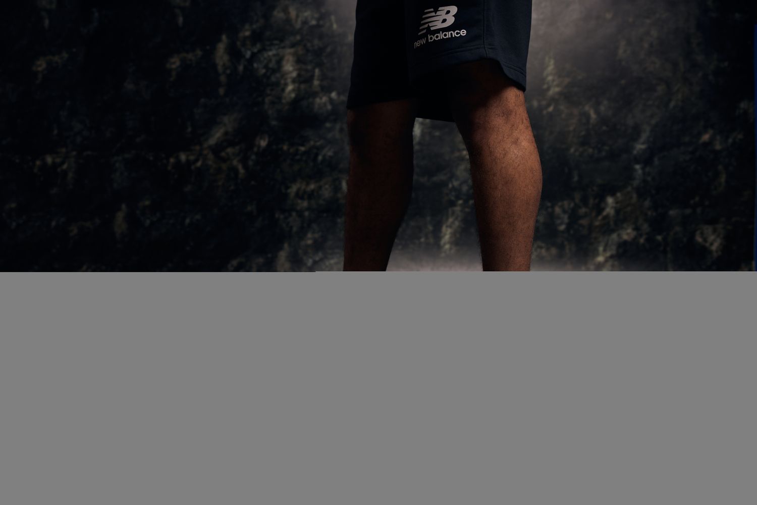 View of black and blue New Balance basketball shoes.